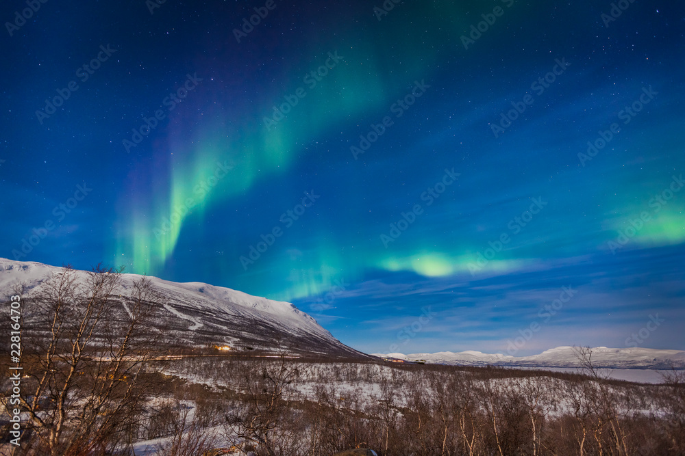 Display of aurora borealis in full moon light, Abisko, Sweden