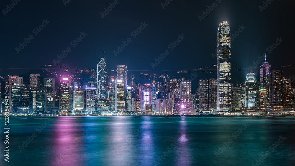 Obraz premium Commercial Building With Water Reflection In Victoria Harbor At Night On October 8, 2018