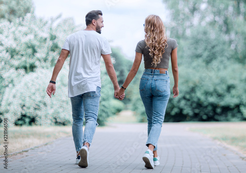 Photography Couple in love walking in park holding hands