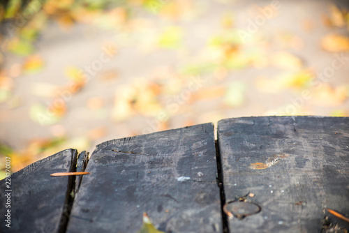 Bright autumn blurred background and edge of a wooden table