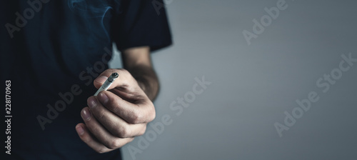 Caucasian man holding cigarette. Smoking concept © andranik123