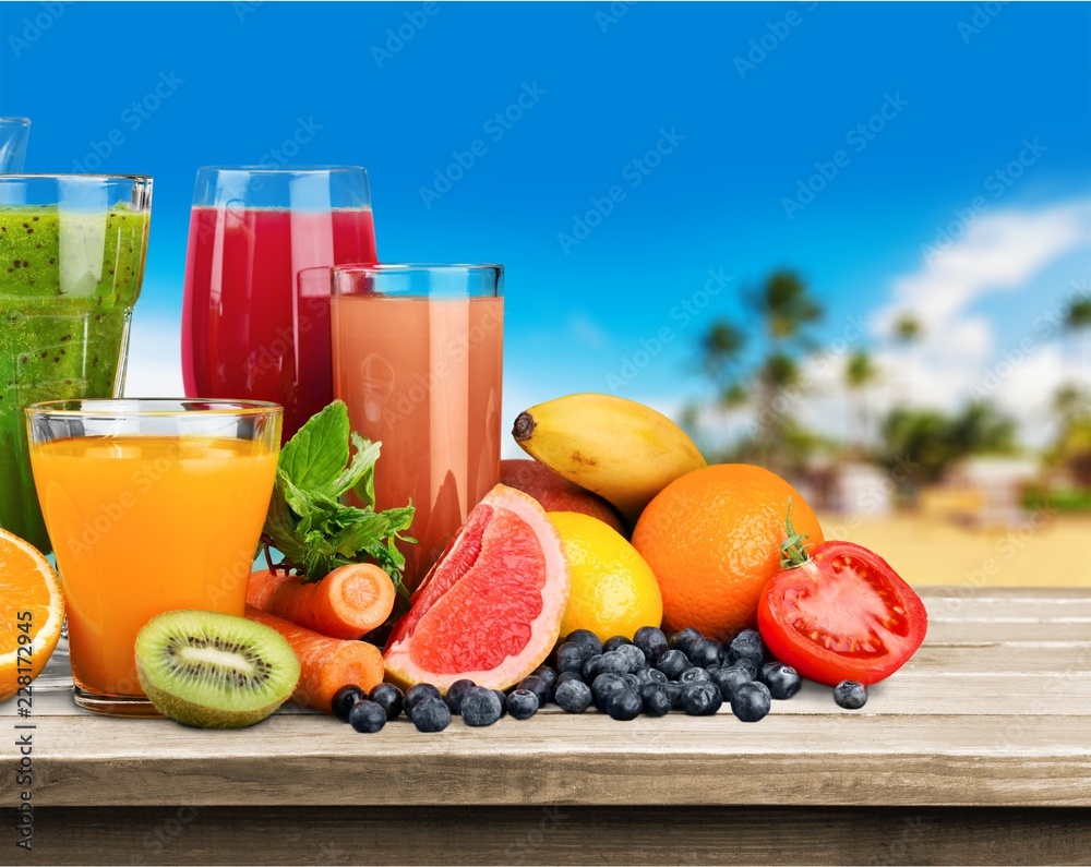 Fresh ripe healthy fruits and juices in glasses Fresh ripe healthy fruits and juices in glasses