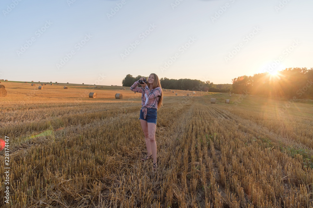 young beautiful girl with camera summer evening young beautiful girl with camera summer evening