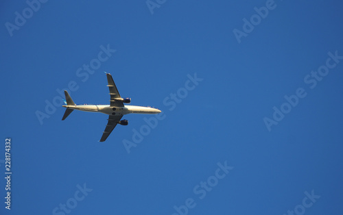 Airplane flying against clear blue sky
