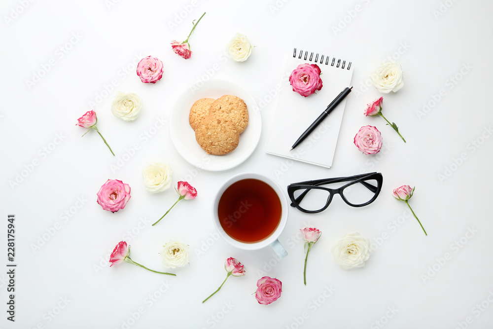 Rose flowers with cup of tea and cookies on white background Rose flowers with cup of tea and cookies on white background