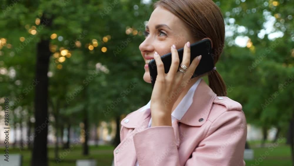 Woman talk on mobile phone outside, face close up Woman talk on mobile phone outside, face close up