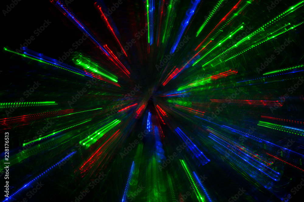 Obraz premium multicolored rays flying to the sides on a black background, beautiful fireworks, lighting effects, abstract concept