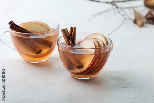 Hot cozy autumn  drinks with apple slices