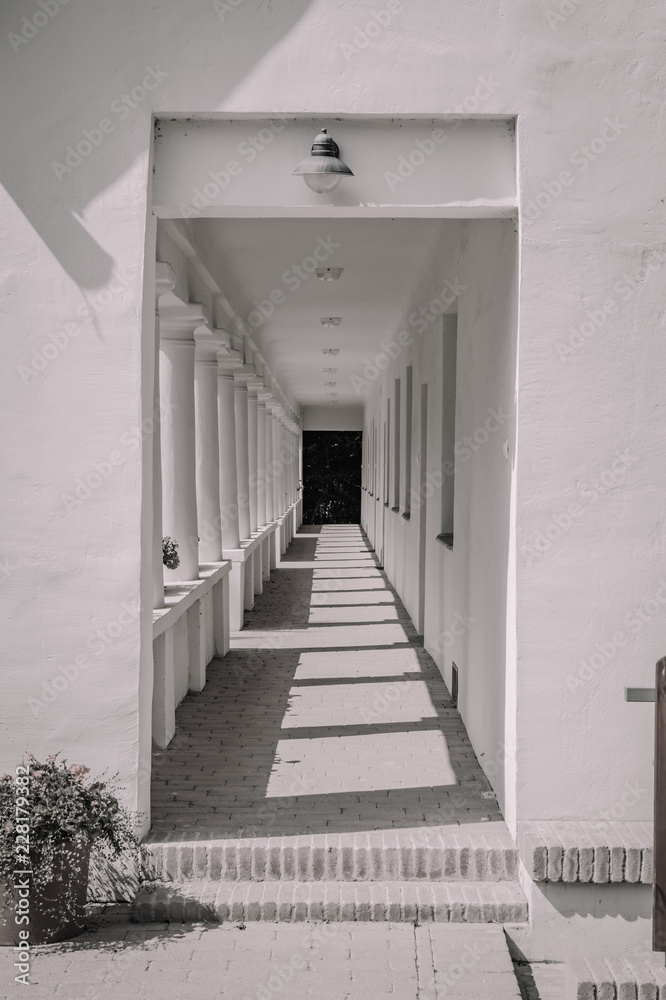 black & white corridor with doors