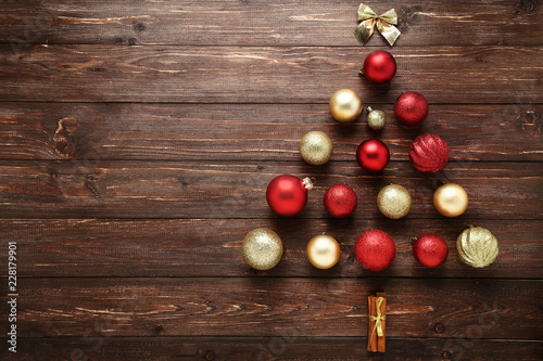 Baubles in shape of christmas tree on wooden table