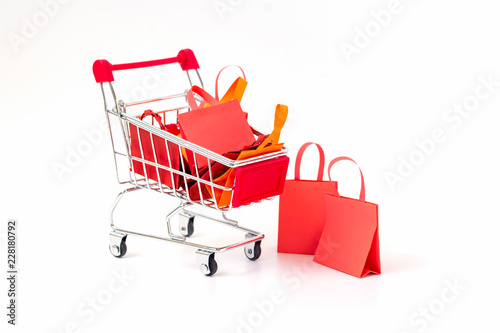 Shopping bag full on shopping cart on white background.