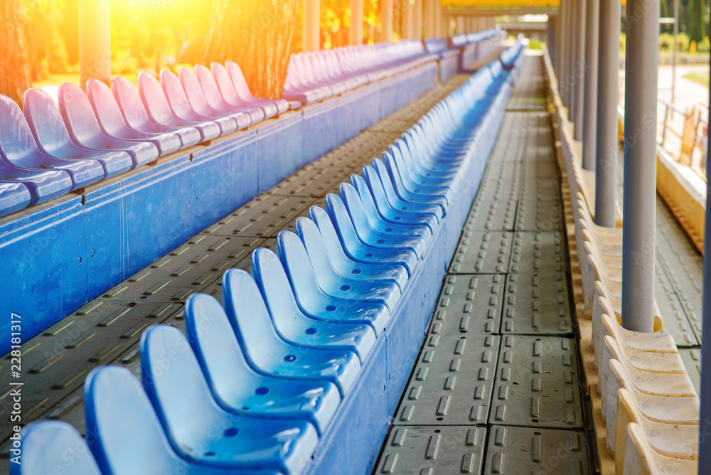 Fototapeta premium Empty plastic chairs in the stands of the stadium