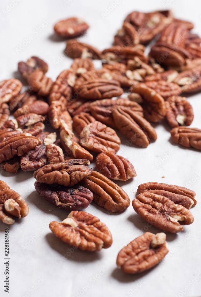 Pecan nuts pile on white background isolated. Pecan nuts pile on white background isolated.