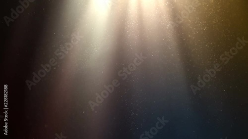 Flying dust particles on abstract background with colorful gradient and rays of light. Good for wedding backgrounds or festive titles. photo