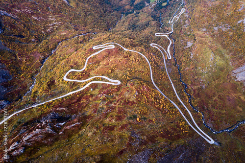 Aerial Drone Panorama view of Winding Road in Norway Scandinavia with Cars and Trees in Fall Autumn