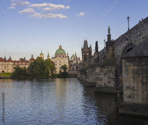 View of Charles Bridge in Prague, Czech Republic. Gothic Charles Bridge is one of the most visited sights in Prague. Architecture and landmark of Prague, golden light, sunny summer day