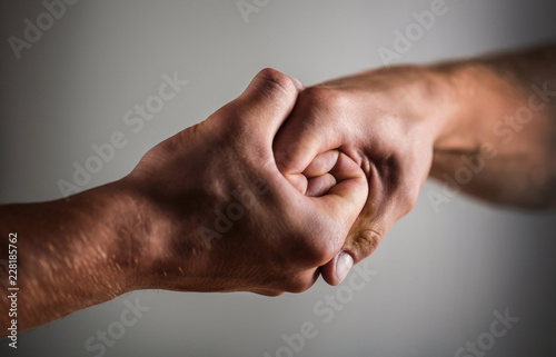 Male hand united in handshake. Man help hands, guardianship, protection. Two hands, isolated arm, helping hand of a friend. Handshake, arms. Friendly handshake, friends greeting. Rescue, helping hand.