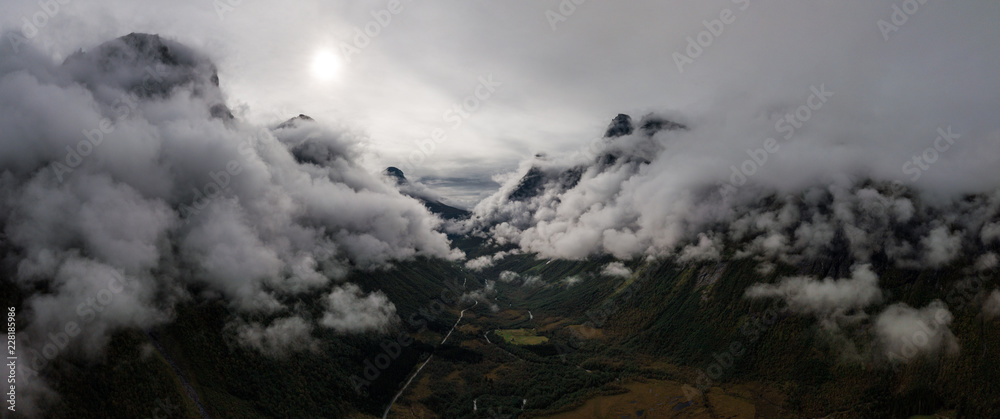 Aerial Drone Panorama view of Large Mountain Covered in Fog, Trees, Forest in Norway