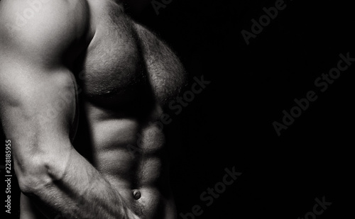 Six pack, abs, strong chest. Sexy muscular male torso six packs, ab. Athletic man training with naked chest and strong biceps on hands. Strong male, torso man. Sportsman, muscles, athlete, naked torso