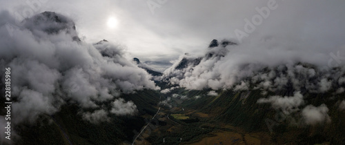 Aerial Drone Panorama view of Large Mountain Covered in Fog, Trees, Forest in Norway