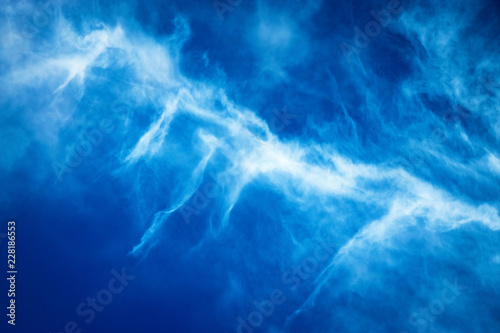 blue sky with white spray cloud