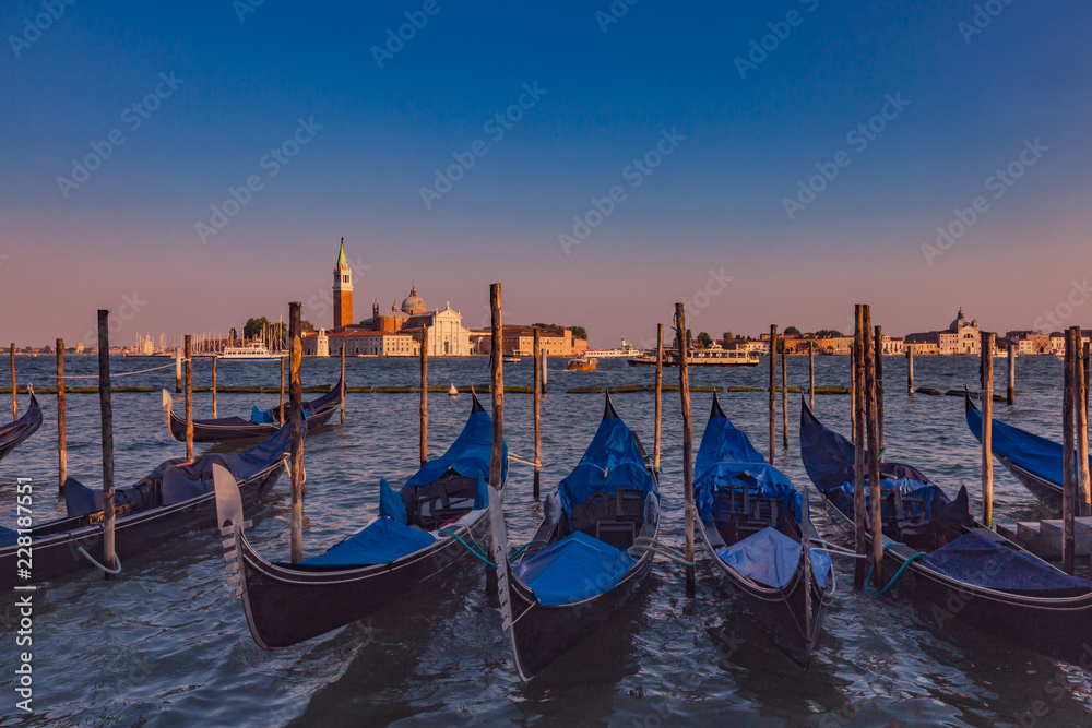 Gondolas by St. Marks Square and San Giorgio Maggiore at dusk in Venice, Italy