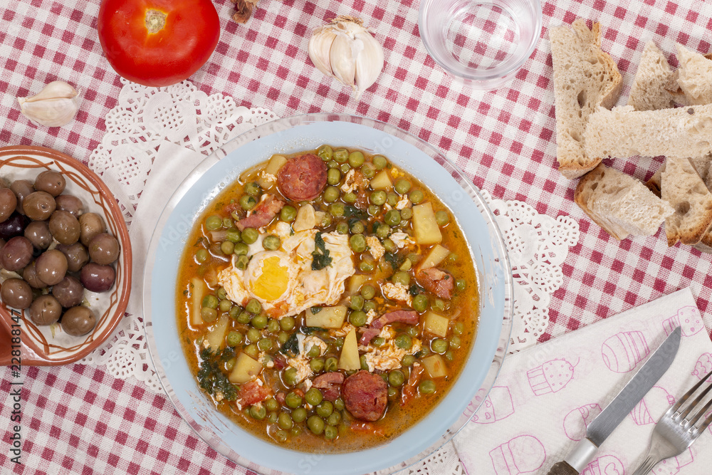 Fototapeta premium green peas with egg, potatoes and chorizo