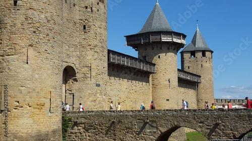 In the old city of Carcasonne, people crossing the defensive bridge to enter the Castle photo