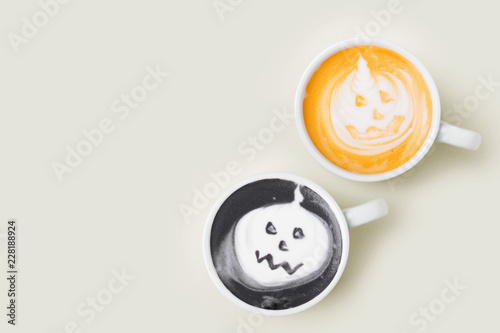 Coffee cup with halloween pumpkin on pale background. Halloween concept. Flat lay, top view