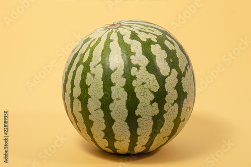 Watermelon fruit on a yellow background.