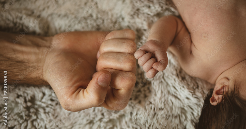 hands of dad and baby
