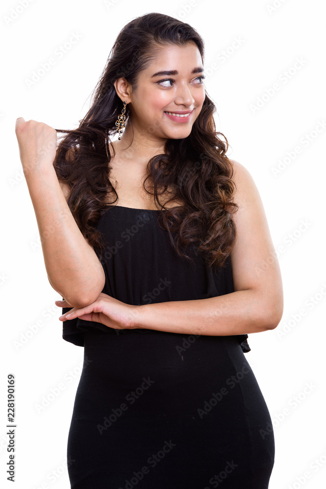 Young happy Indian woman smiling while thinking and playing with Young happy Indian woman smiling while thinking and playing with