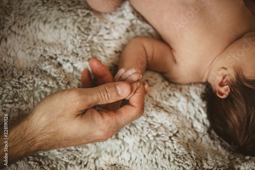 dad holding baby's hand