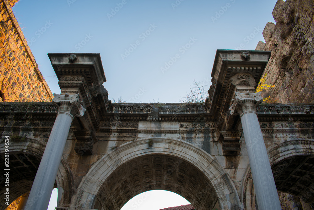 old ancient ruins of Hadrians Gate in Antalya turkey against blue sky  