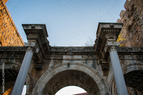old ancient ruins of Hadrians Gate in Antalya turkey against blue sky 