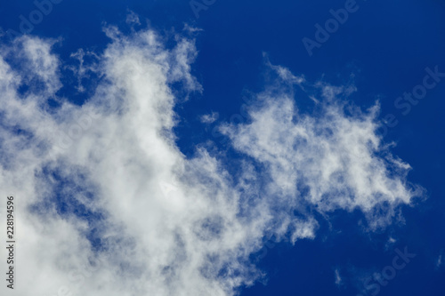 Background of transparent white clouds in a light blue sky illum photo