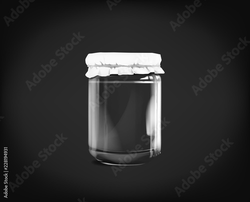 Empty glass jar isolated on dark background.