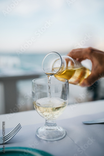 glass of white wine on table in restaurant