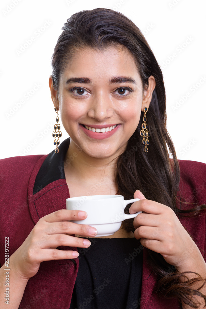 Face of young happy Indian businesswoman smiling while holding c Face of young happy Indian businesswoman smiling while holding c