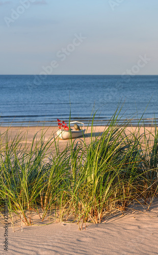 Düne am Ahlbecker Strand mit Seegras im Hintergrund Boot und Ostsee photo