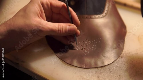 ancient workshop with expert shoemaker during the processing of leather to produce shoes with vintage effect
