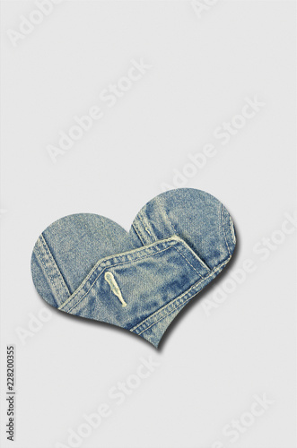 Jeans Heart on white  Background / jeans heart  on white, beige background, close up, vertical
