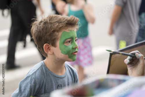 Boy with green paint on face