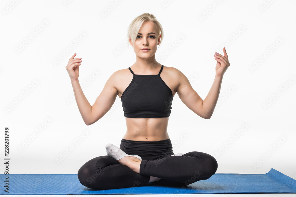 Portrait of woman sitting on the mat while practicing yoga, isolated on white background Portrait of woman sitting on the mat while practicing yoga, isolated on white background