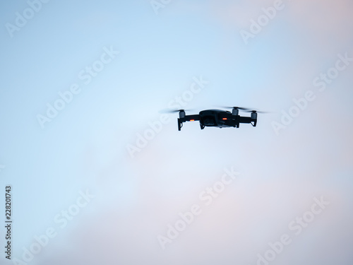 Drone hovering against Blue sky.