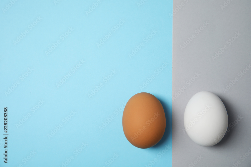 Fototapeta premium Raw chicken eggs on color background, top view. Space for text