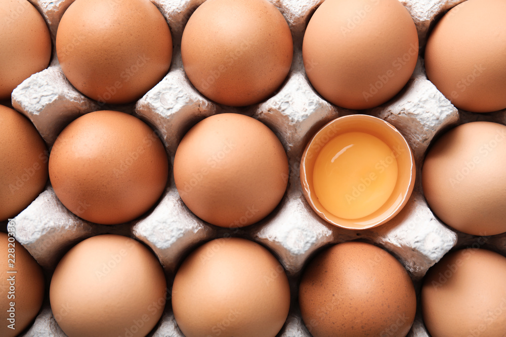 Raw chicken eggs in carton, top view Raw chicken eggs in carton, top view