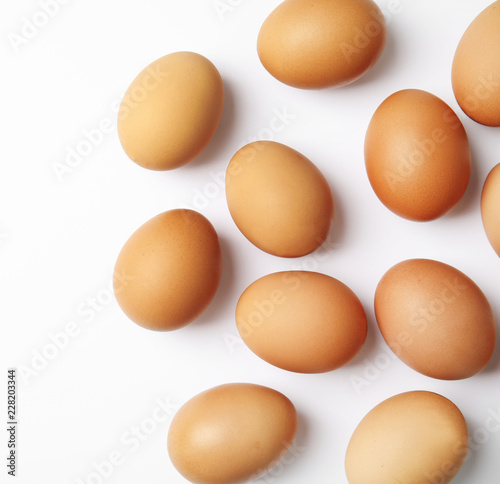 Raw chicken eggs on white background, top view