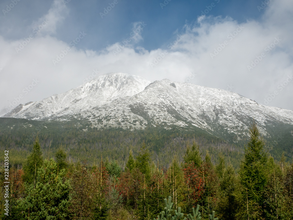 First snow in High Tatras. Beautiful winter mountains. Panorama of High Tatras. Big mountains and lake.