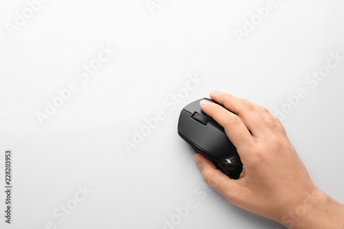 Woman using computer mouse on white background, top view. Space for text